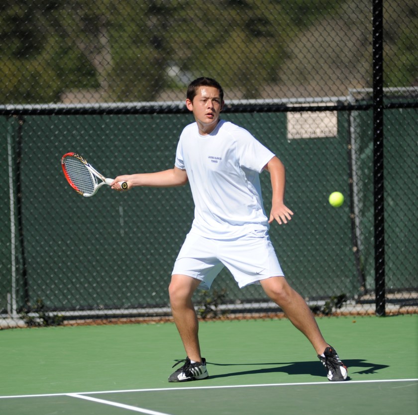 Martin Barnick takes a forehand return in high school tennis competition